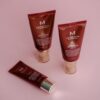 BB cream tubes on a vibrant pink background showcasing skincare and cosmetics.